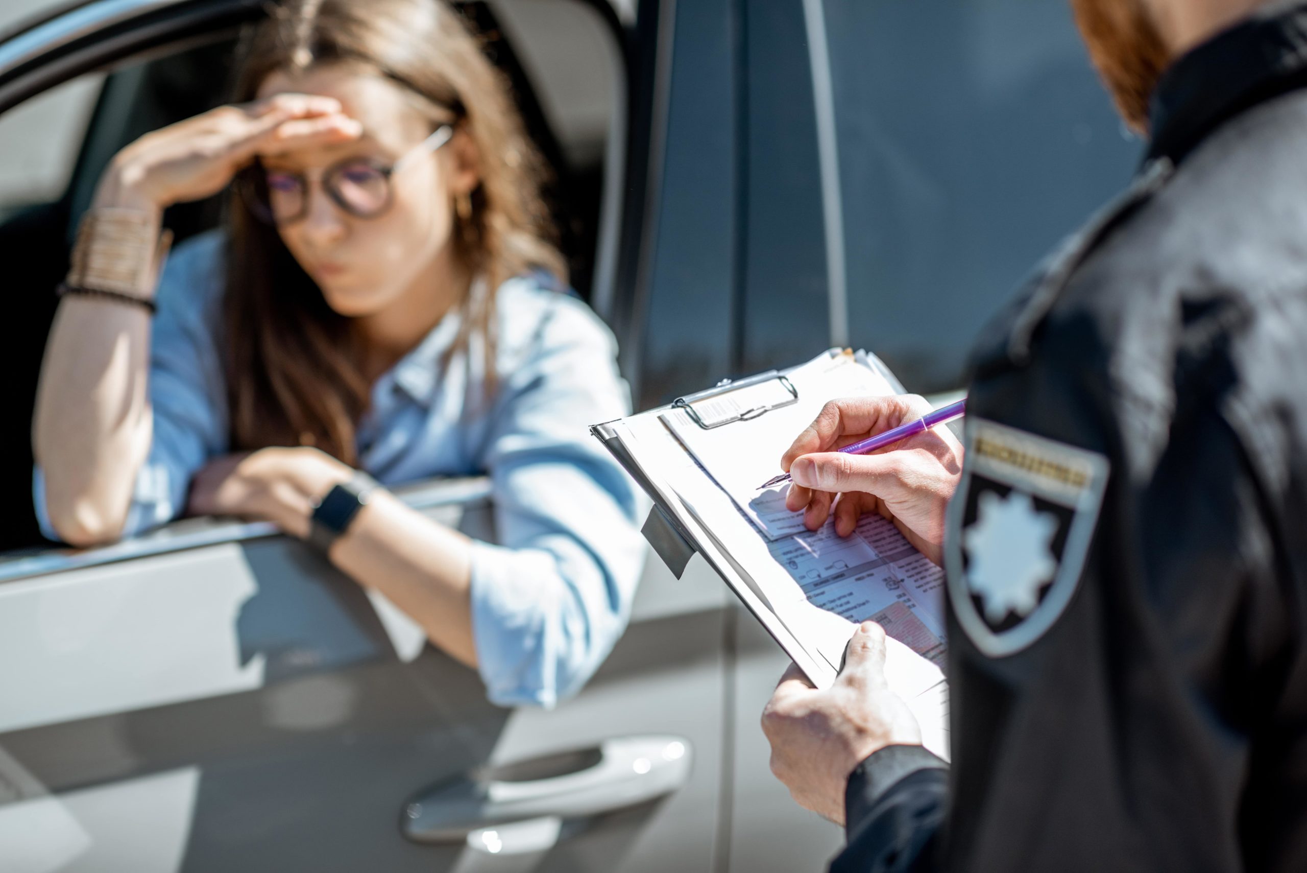 A woman receives a traffic citation